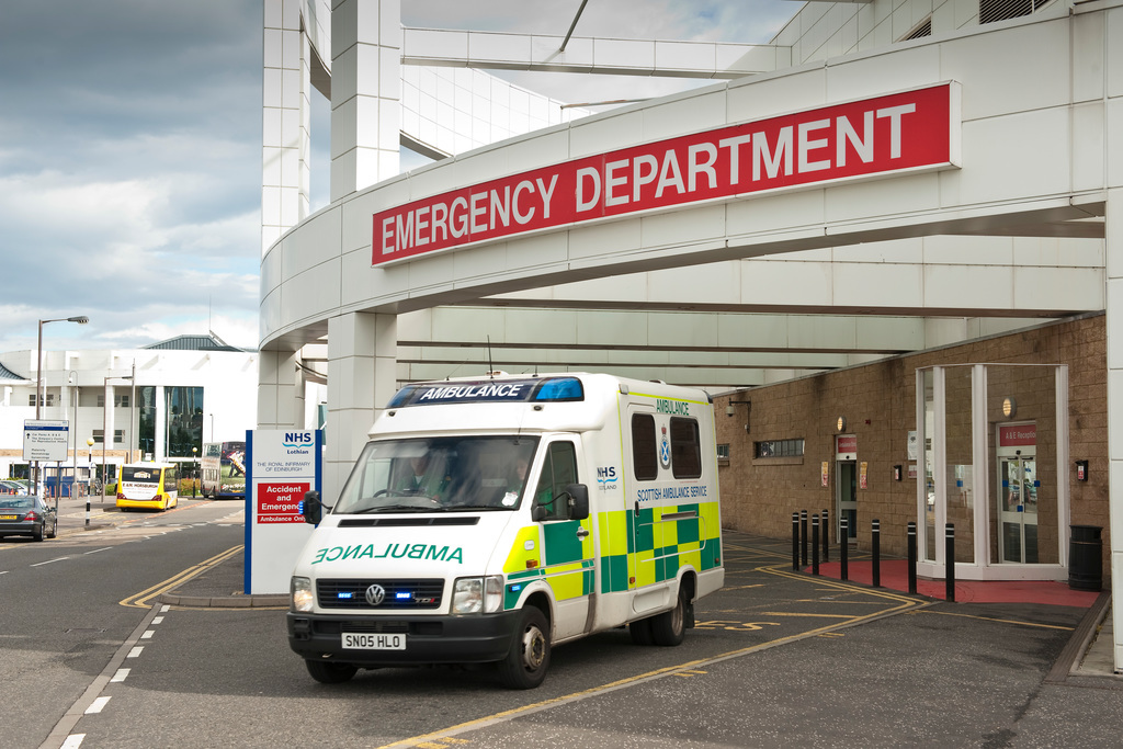 Exterior shot of an emergency department with an NHS Scotland ambulance parked outside.