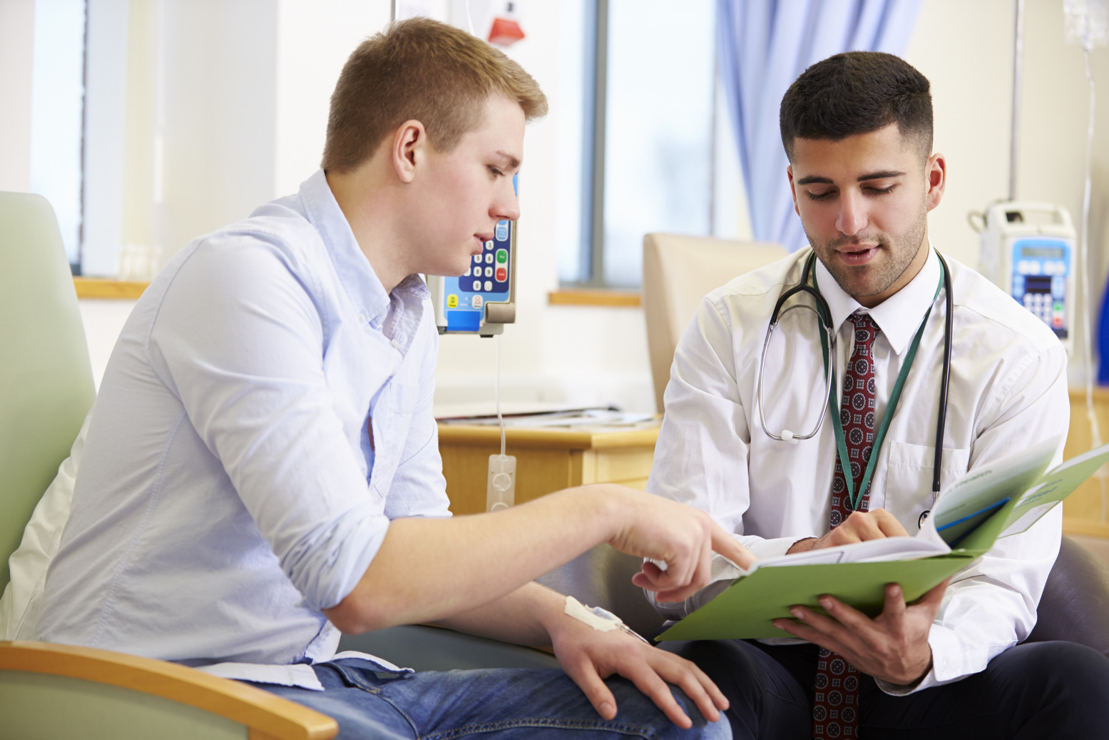A doctor discussing results on a chart with a patient.