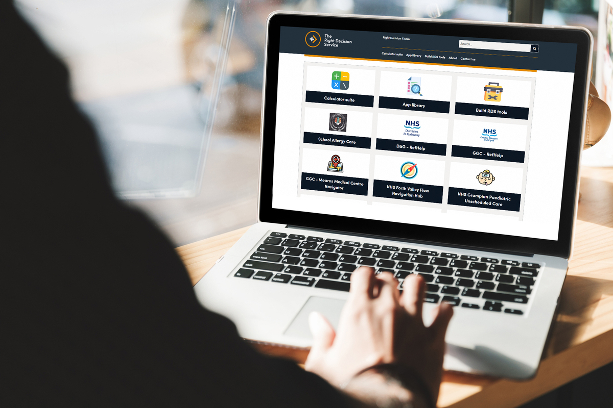 A person sitting with a laptop and accessing the Right Decision Service.