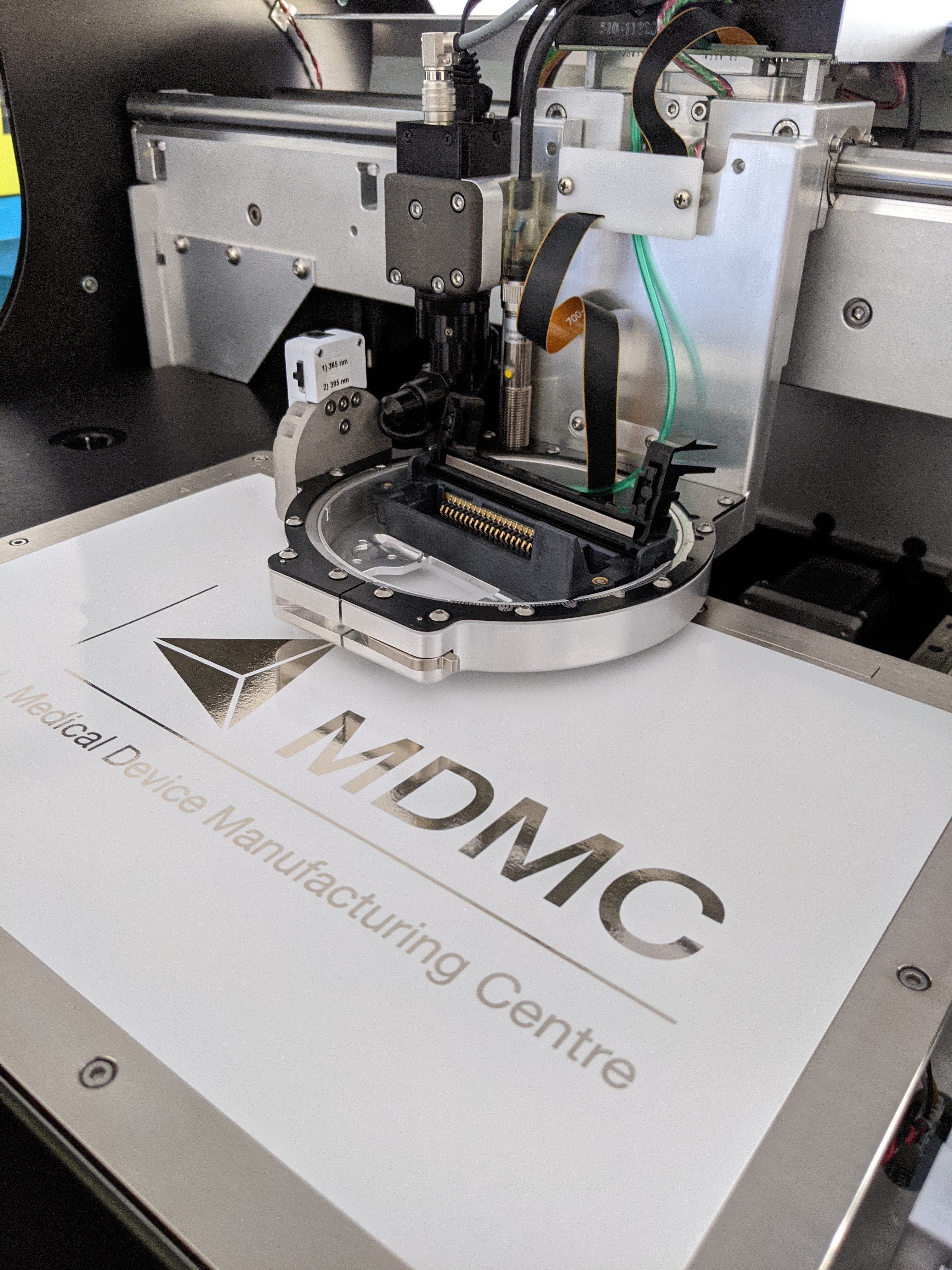 The Medical Devices Manufacturing Centre (MDMC) logo on a inkjet printer